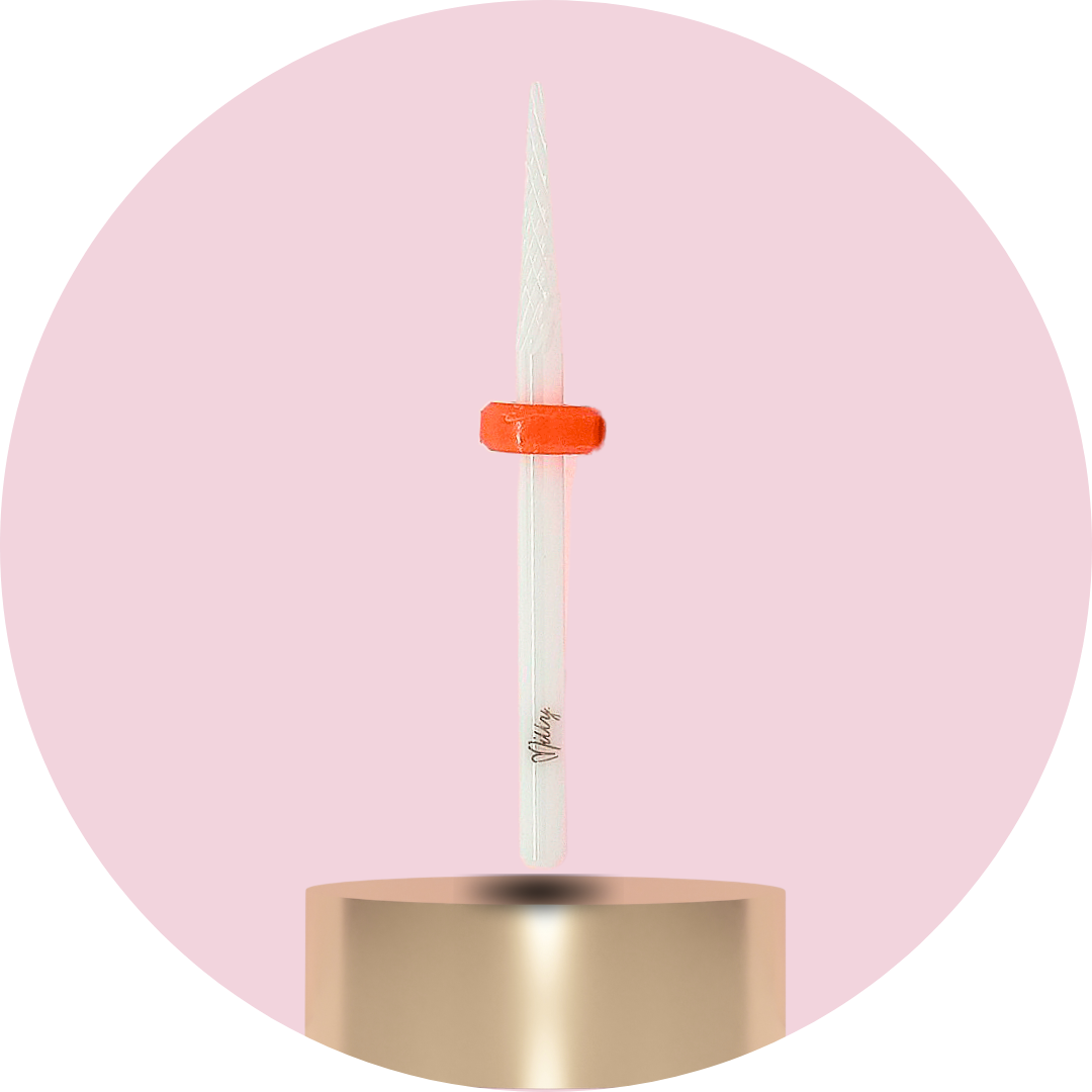 Candle with a gold holder on a pink background
