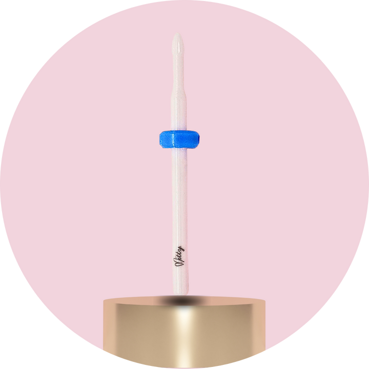 Candle with a blue wick on a pink background