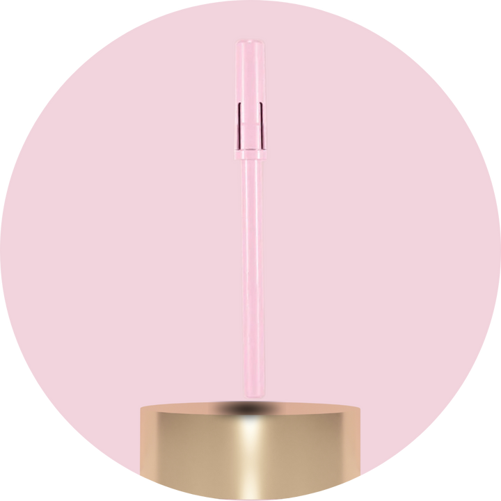 Pink and gold cylindrical product on a pink background